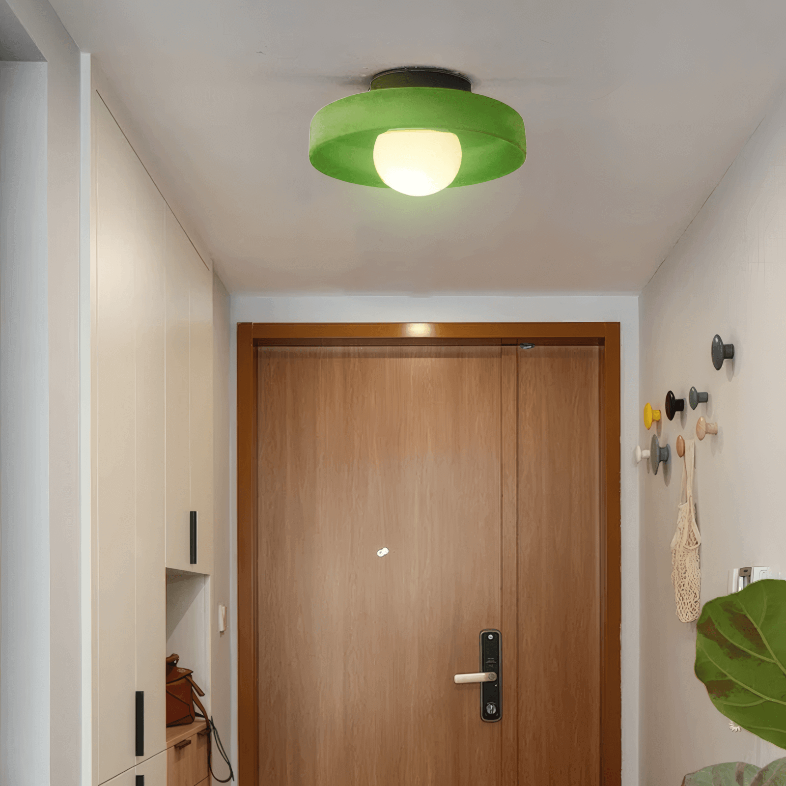 modern round ceiling light in dark green room, green metal glass